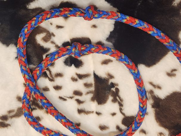 8 plait reins with blue, red and tie dye. 8 cords flat with knots and an 8 square plait in between.
