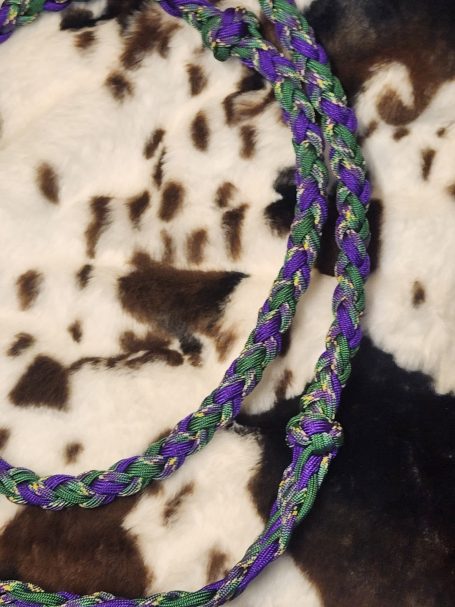 8 plait reins with purple, green and plum crazy. 8 cords flat with knots and a double 4 round plait in between.