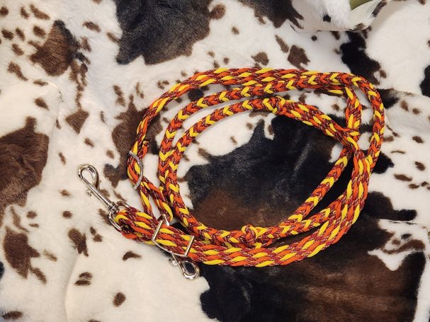 8 plait reins with yellow, neon orange and fire fall. 8 cords flat with knots and an 8 square plait in between.